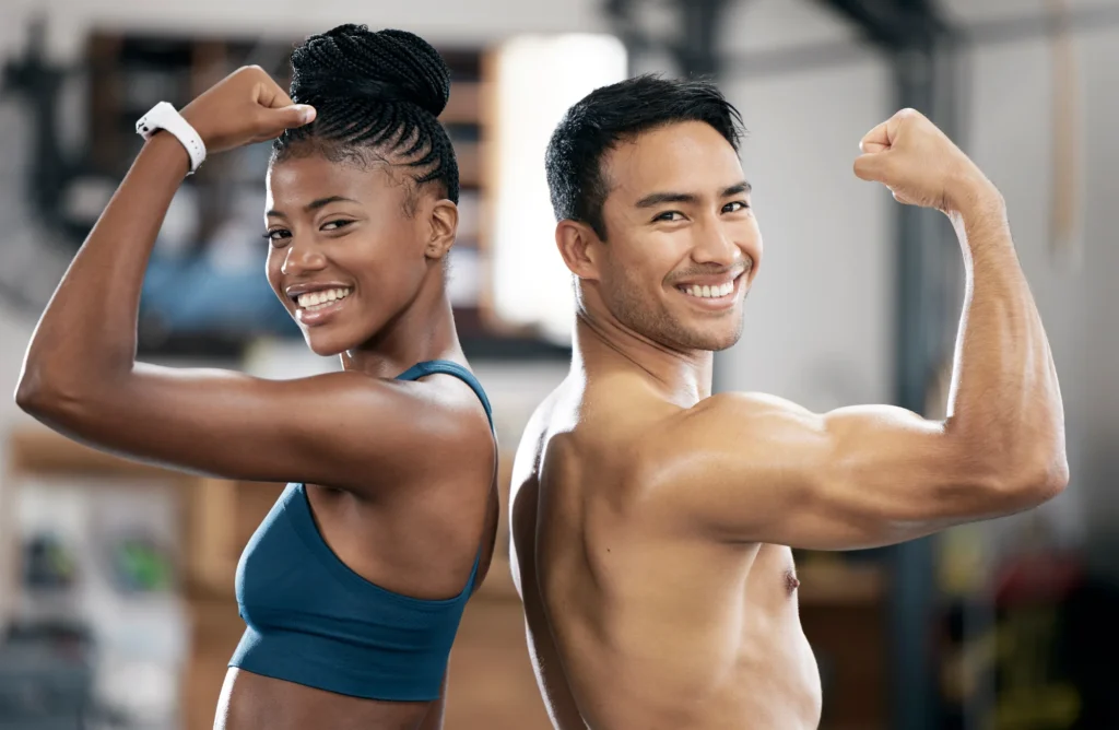 A perfect Gym Guy with a girl showing their biceps | Boost Wellness Clinic