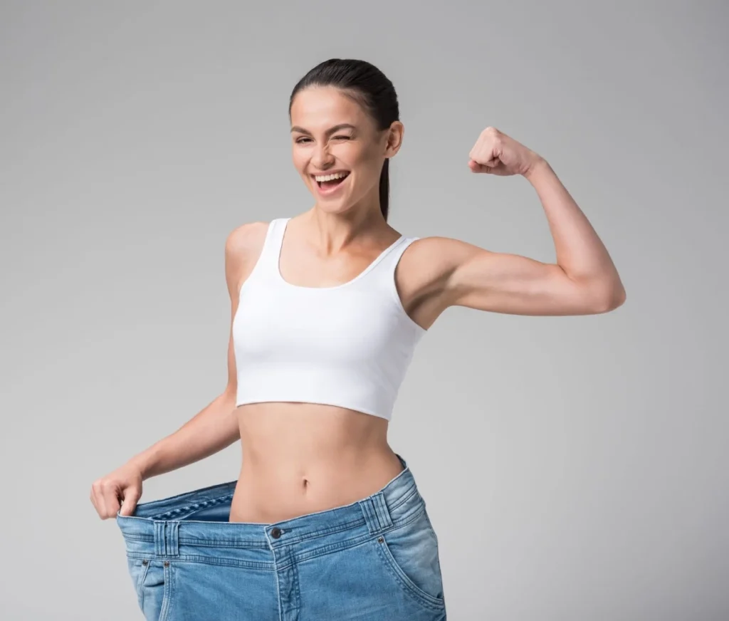 Lady with happy face measuring her body after tirzepatide in Missouri City, TX