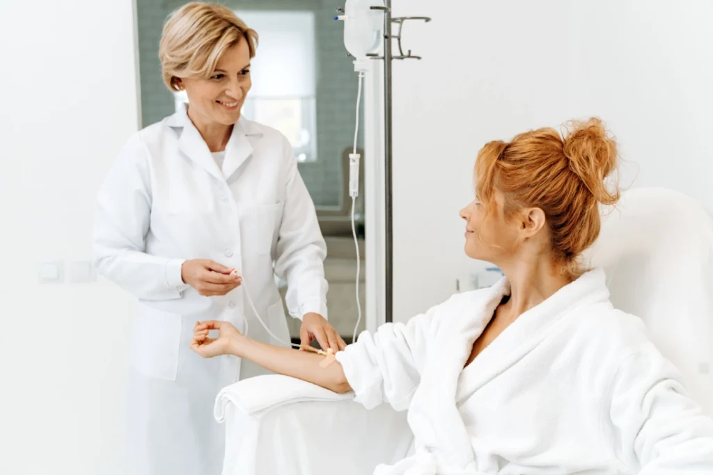 Nurse Practitioner giving glutathione infusion to a lady at boost wellness clinic