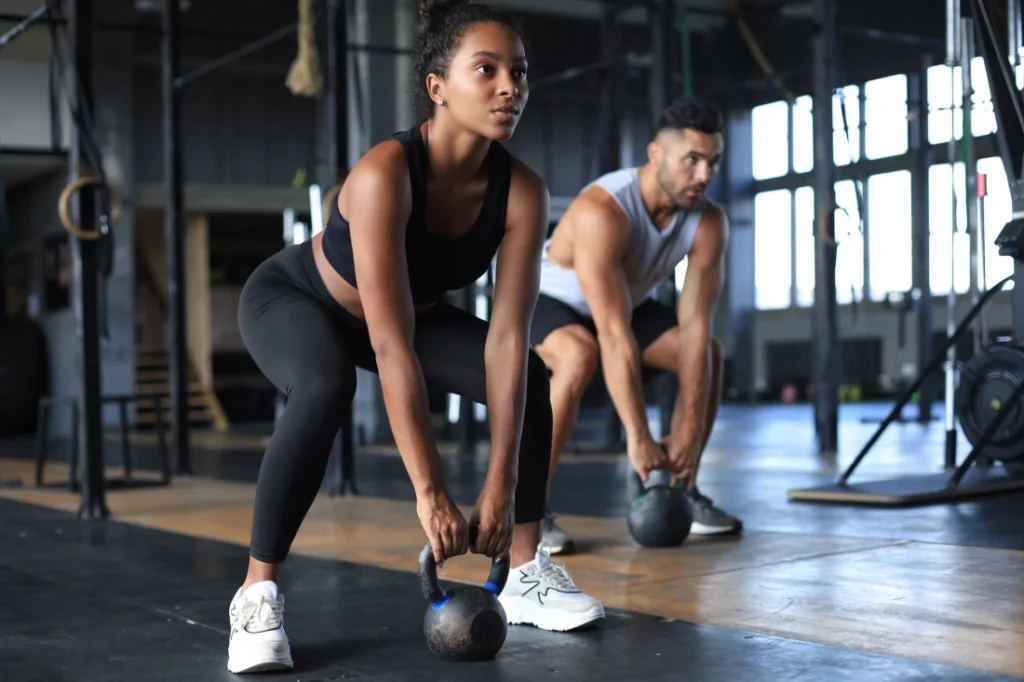 Lady and Man doing workout in a gym | boost wellness clinic