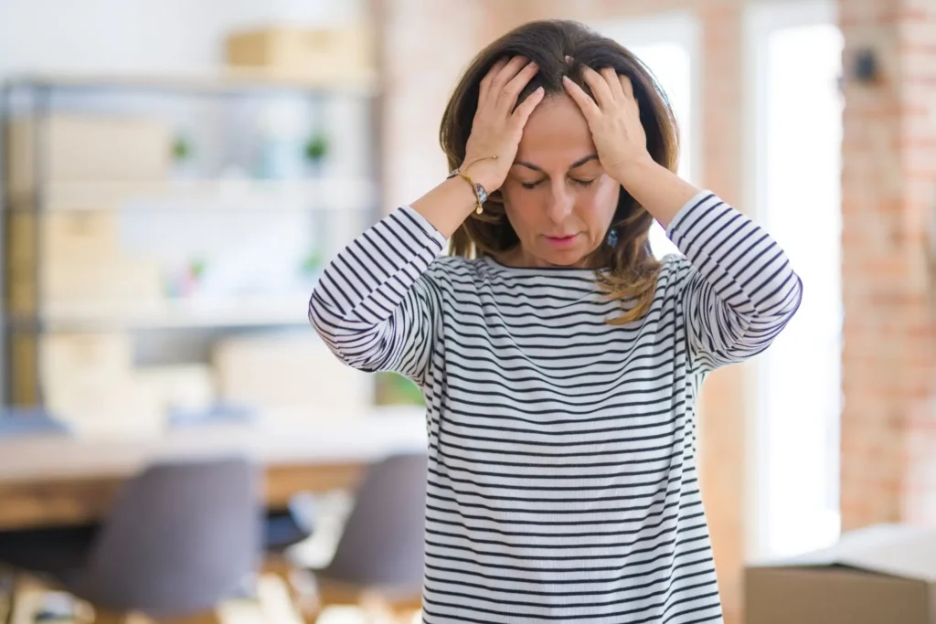 Lady holding her head and seeking for migraines treatment in missouri city